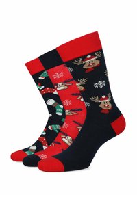 Trzy pary świątecznych skarpetek. Mieszanka bawełny, w kolorze granatowym i czerwonym, z motywami reniferów, śnieżynkami i wzorami świątecznymi. Rybkowane mankiety w kolorze czerwonym.
