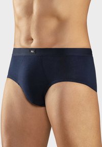 Navy blue cotton briefs with a textured waistband and logo tag. Features a snug fit and smooth surface, designed for comfort and support.