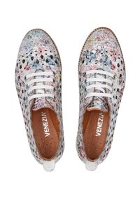 Lace-up shoes with a perforated leather upper featuring a multicolor floral pattern, white laces, and a brown inner lining.