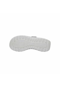 White shoe sole with a textured grip pattern, rounded shape, and slight curve at the heel. Features a smooth surface and raised edges.