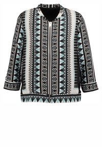 Geprinte jas met geometrische ontwerpen in zwart, wit en lichtblauw. Materiaal is glad met een ritssluiting aan de voorkant en driekwartmouwen.