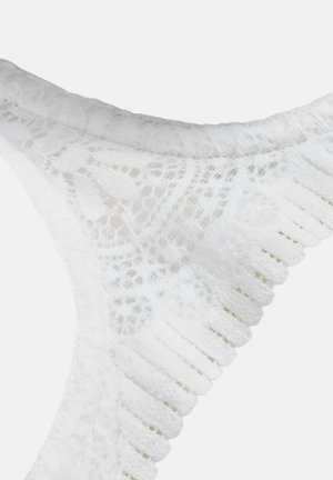 Hvid blonde trusse med et blomstermønster, der har bølgede kanter og en blød, tekstureret overflade. Livbåndet er elastisk for komfort.