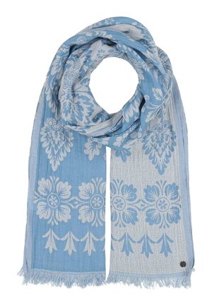 Light blue scarf with white floral patterns and tassels on both ends, loosely folded with a small round metal tag near the fringe.