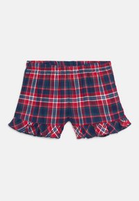 Punane, tumesinine ja valge ruuduline lühike pükskostüüm elastse vöökohtade ja volditud äärtega, esitledes valgel taustal.