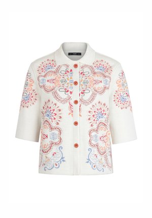 Valge lühikeste varrukatega jakk värvilise lillemustrilise tikkimisega ja pruunide esiekraanil asuvate nuppudega.
