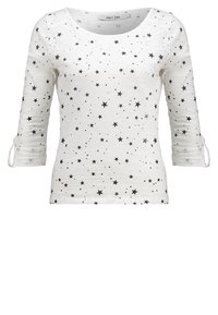 T-shirt blanc à manches longues avec motifs d'étoiles noires, doté d'un col rond et de manches retroussées. Confectionné en tissu doux et léger.