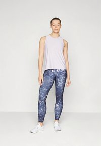 Light purple sleeveless top paired with navy leggings featuring a marble pattern. Both made of stretchy fabric, suitable for activewear.