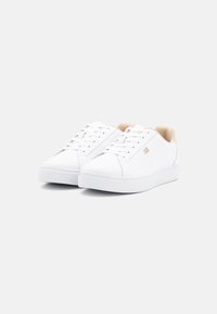 Weiße Low-Top-Sneaker mit einem glatten Synthetik-Obermaterial, runder Zehenpartie, Schnürverschluss und hellbeigen Akzenten an der Ferse.