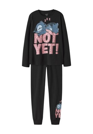 Pyjama noir à manches longues avec un personnage bleu endormi en dessin animé au-dessus du texte "NOT YET!" en grandes lettres roses.