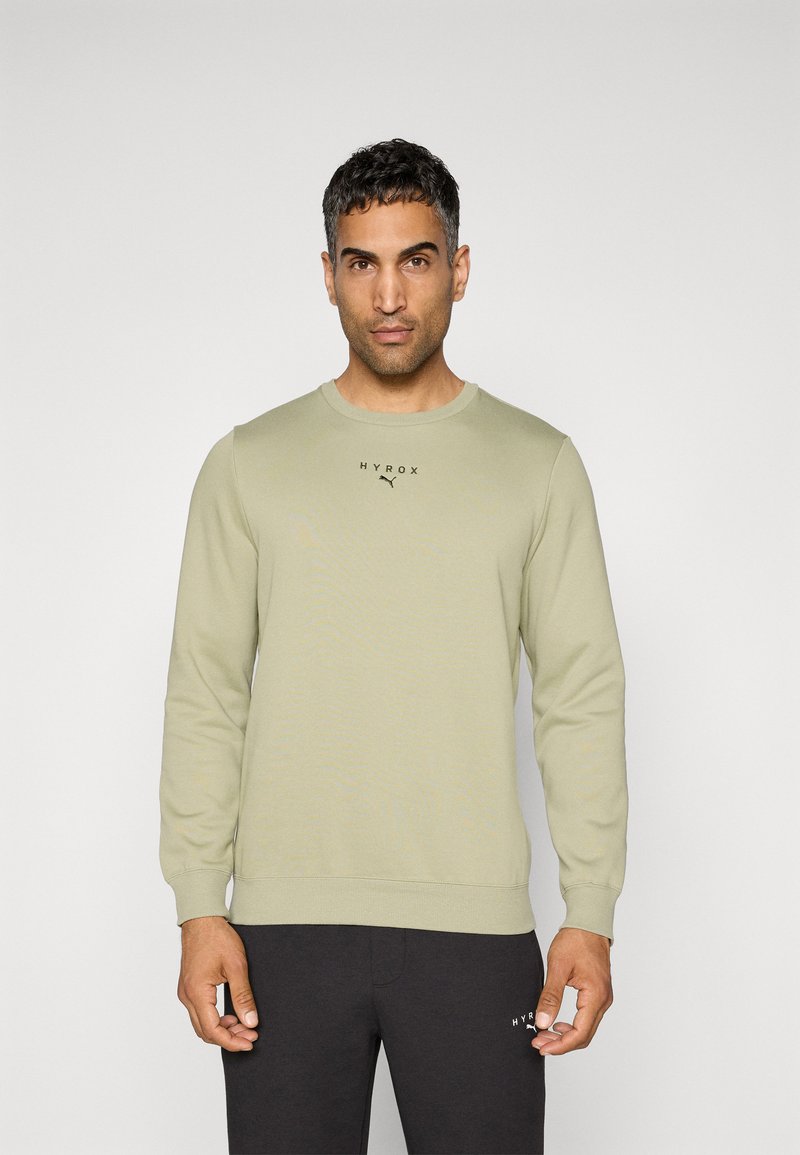 Lys grøn sweatshirt med langeærmer, rund halsudskæring og ribbede manchetter. Har "HYROX" logo i sort på brystet. Glat tekstur.