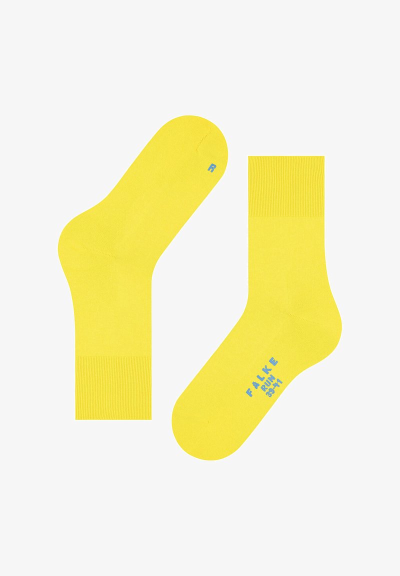 Gelbe Socken mit glatter Textur, mit einem gerippten Bündchen und blauem Text auf den Sohlen. Standard Design in knöchellanger Ausführung.