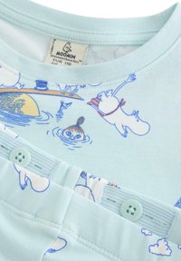 Light blue children's clothing set with Moomin character prints, featuring snap buttons and a Moomin label at the neckline.