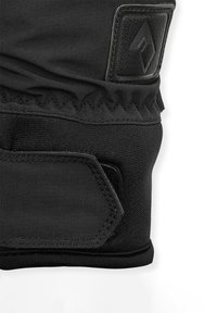 Gant en textile noir avec tissu renforcé, zone rembourrée au niveau du poignet, accents texturés et manchette élastique pour un ajustement sécurisé.