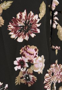 Black floral fabric featuring large pink, cream, and burgundy flowers with green leaves; soft texture; buttons are visible along the edge.