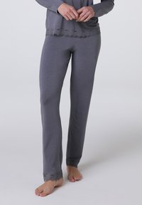 Set di pigiama grigio con maniche lunghe e bordo in pizzo all'orlo. I pantaloni presentano dettagli in pizzo ai polsini. Tessuto morbido con una consistenza liscia.