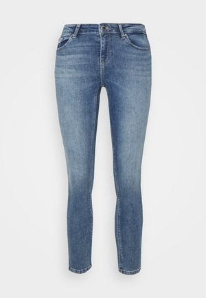 Skinny-fit jeans in medium blue denim. Features five pockets, button closure, and slight fading for a worn look. Clean hem and no embellishments.