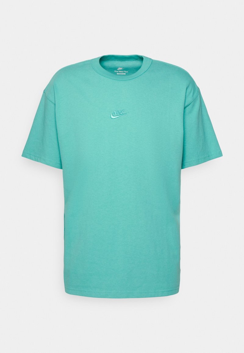 Turquoise cotton t-shirt with short sleeves, crew neck, and a small white Nike logo on the chest. Smooth texture and relaxed fit.