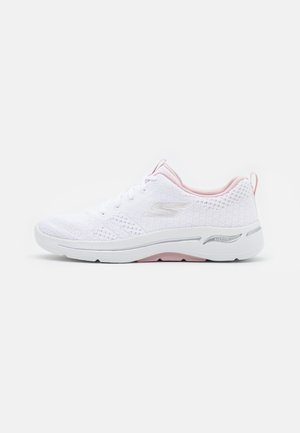 White athletic sneaker with light pink accents, mesh upper, lace-up closure, cushioned sole, and "Arch Fit" support branding on the side.