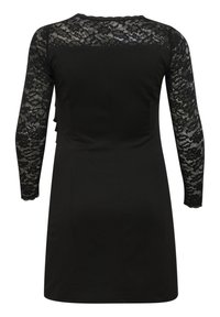 Abito lungo nero con maniche in pizzo floreale e yoke, silhouette aderente e corpo in tessuto solido visto da dietro.