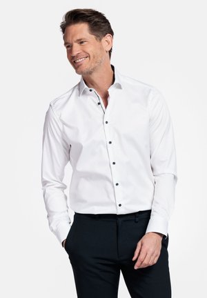 Witte overhemd met knopen in het zwart, lange mouwen en een klassieke kraag. Soepele structuur met een getailleerde pasvorm.