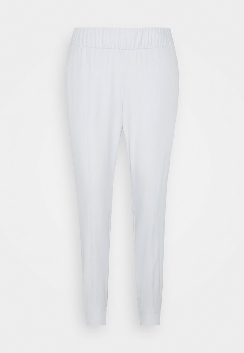 Ljusgrå, elastiska joggers med smalnande ben. Slät yta, inga synliga mönster eller detaljer. Manschetter vid vristerna.