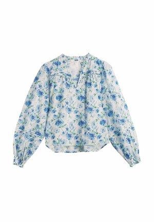 Langærmet hvid bluse med blåt blomsterprint, V-udskæring, løs pasform og rynkede ærmekanter.