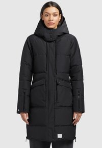 Black padded parka coat featuring a hood, zippered pockets, drawstrings, and a logo patch on the hem. Smooth texture, mid-length design.