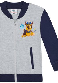 Grijs en marineblauwe zip-up jas met een Chase-hondpersonage van Paw Patrol en een blauwe stergrafiek op de borst.