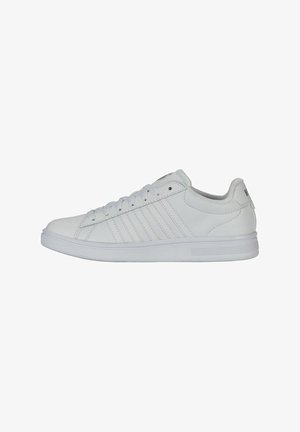 White sneaker with a smooth synthetic upper, six eyelets, and horizontal stitch detailing on the side. Rounded toe and textured sole.