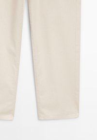 Beige pants with a smooth texture, featuring straight legs and contrasting stitching along the seams. No visible hardware or accents.