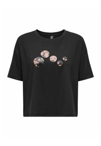 Camiseta de algodón negra con un corte holgado que presenta un gráfico de patrones circulares en varios tamaños en rosa y negro en la parte delantera.