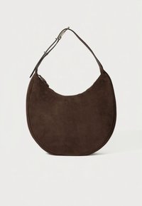 Ruda zomšinė petnešėlė su pusapvale, pusmėnulio formos kūnu ir viena petneša. Turi švarias linijas ir minimalistinį dizainą.