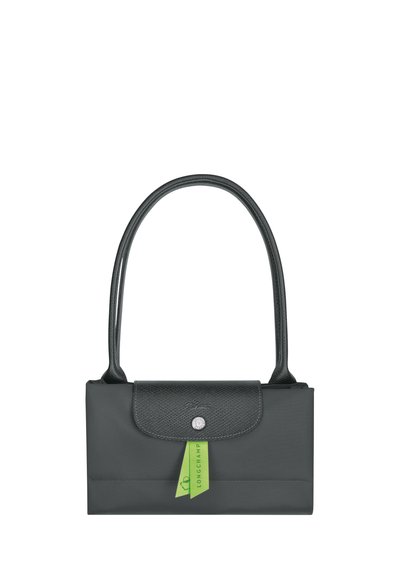 Gray handbag with a smooth finish, featuring a textured flap, a silver snap closure, and a long handle. Includes a green brand tag.