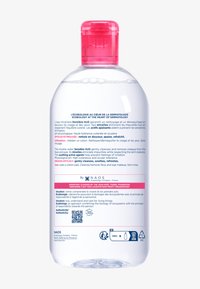 Transparente Plastikflasche mit einer pinken Kappe. Enthält klare Mizellenwasser. Etikett in Blau und Pink mit Text in mehreren Sprachen, einschließlich Anwendungshinweisen.