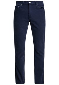 Marinblå manchesterjeans med rak skärning, framfickor och knappstängning. Mjuk textur med fin revärmönstring över hela.