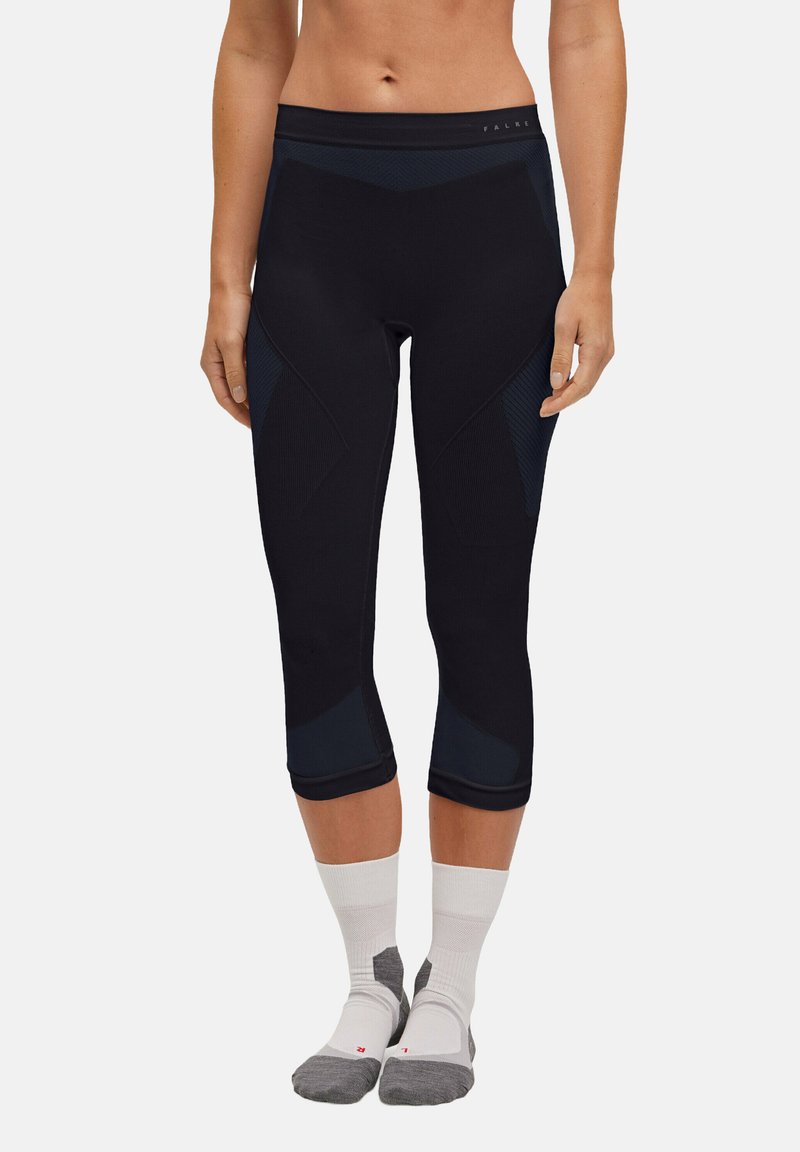 Black athletic capri pants with a fitted design, featuring textured panels and a high waistband, paired with white and gray sport socks.