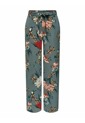 Pantalon large taille haute avec base verte, imprimé floral en rouge, blanc et jaune, et une ceinture assortie en tissu nouée à la taille.
