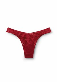 Red lace thong with floral pattern and elastic waistband, laid flat on a white background.