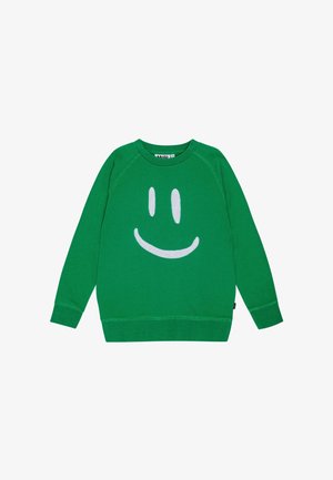 Grøn langærmet sweatshirt med et stort hvidt smilende ansigt på fronten og rund halsudskæring.