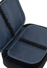 Étui zippé en nylon bleu avec des garnitures noires, comportant des bandes élastiques pour l'organisation à l'intérieur, et une texture intérieure lisse.