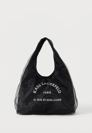 Borsa tote nera riutilizzabile con lati trasparenti, con scritta bianca "Karl Lagerfeld Paris 21 Rue St-Guillaume" sul fronte.