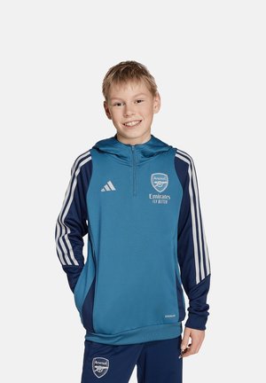 Teal sportieve hoodie met marineblauwe accenten, met een rits aan de voorkant, capuchon, gestreepte mouwen en het Arsenal-logo. Gemaakt van vochtafvoerende stof.