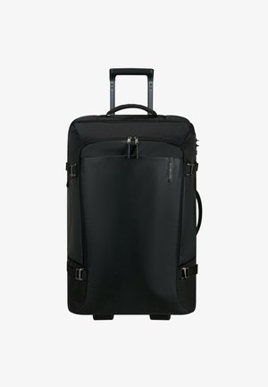 Valise à roulettes noire avec un devant rigide, des côtés en tissu, des doubles poignées supérieures et des sangles latérales ajustables. Roues lisses et poignée télescopique.