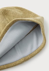 Knit hat with a gold outer texture and a soft, light blue fleece lining, featuring a folded brim and seamless construction.