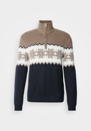 Gebreide trui met een halve rits. Voorzien van een geribde beige kraag, sneeuwvlokpatroon in beige en wit, donkerblauwe body en lange mouwen.