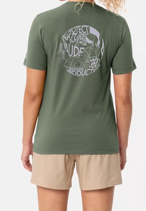 Osoba nosząca zielony T-shirt z nadrukiem o tematyce biwakowej i napisami „Protect Nature”, „Vaude” oraz „Sustainable Products” na plecach.