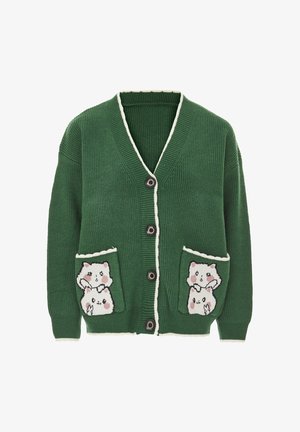 Cardigan verde a maglia con texture a coste, scollo a V, rifiniture bianche e due tasche anteriori con disegni di animali dei cartoni animati. Chiusura a cinque bottoni.