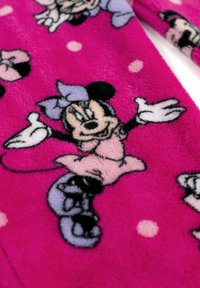 Tessuto morbido stampato di Minnie Mouse in un vivace rosa, con personaggi dei cartoni animati in varie pose, contornati di nero e con accenti viola.