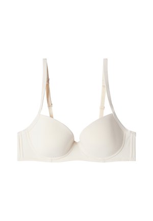 Longline-BH aus weichem Elfenbein-Stoff. Geformte Cups mit dünnen verstellbaren Trägern und nahtlosem Design. Leicht gepolstert für zusätzlichen Halt.