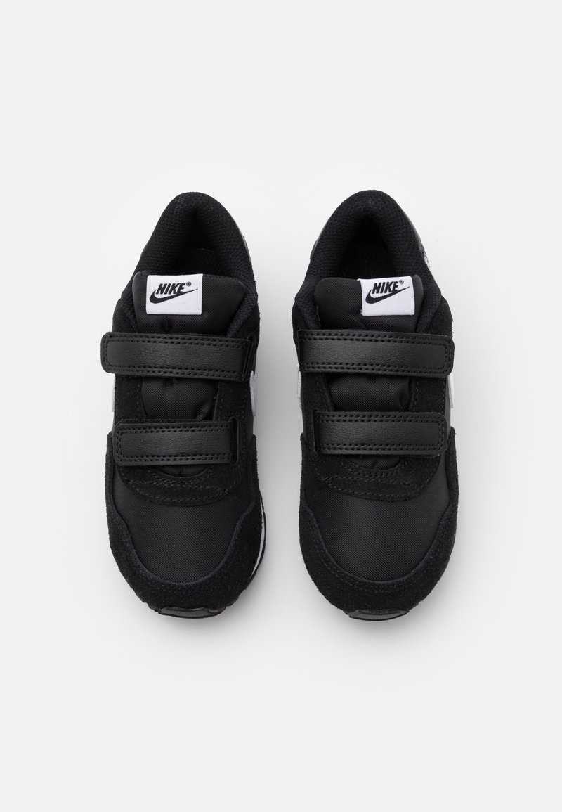 Zapatillas negras de Nike con una combinación de materiales textiles y de ante, que cuentan con dos correas de velcro y un logo blanco en la lengüeta.